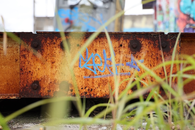 graffiti on rusted metal